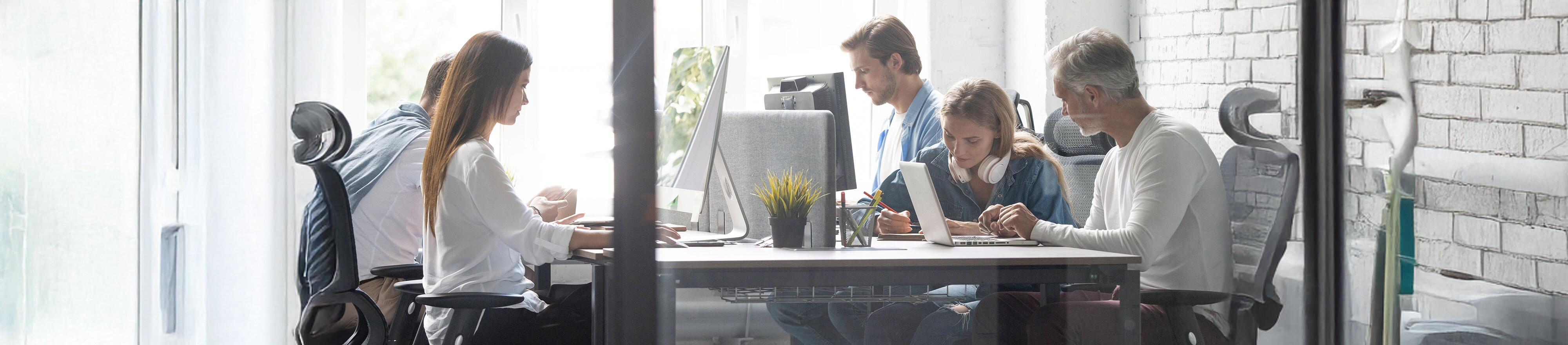 Employees behind a computer in an office